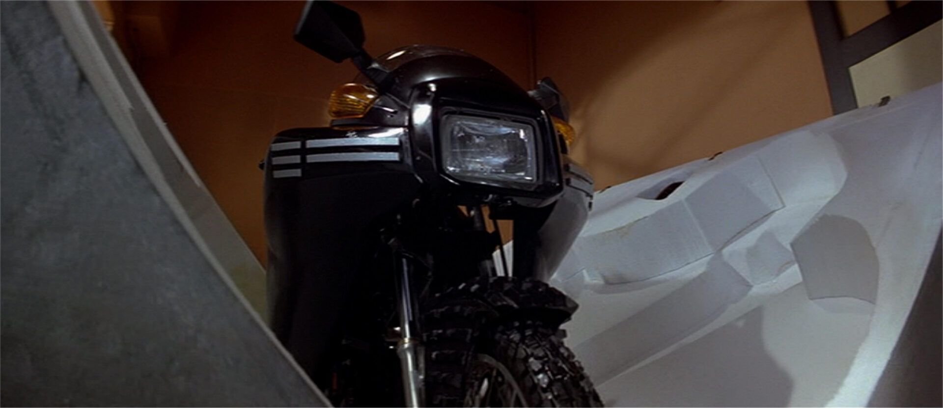 Bond unpacks the Q-branch motorbike.